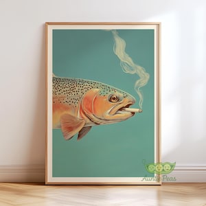 May include: A framed art print featuring a stylized illustration of a fish with a cigarette in its mouth, exhaling smoke. The fish has orange, red, and gray scales, set against a teal background. The artwork is in a wooden frame.