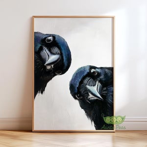 May include: A framed art print featuring two detailed portraits of black birds with dark blue highlights. The birds are positioned at an angle, with their beaks and eyes prominently displayed against a white background. The artwork is in a wooden frame.