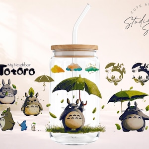 May include: A clear glass tumbler with a wooden lid and a glass straw. The tumbler is decorated with illustrations of characters from "My Neighbor Totoro," including Totoro holding an umbrella. The words "Cute and Creative Designs" are also visible.
