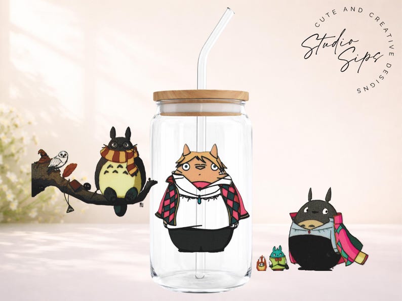 May include: A clear glass tumbler with a wooden lid and a straw, featuring cartoon illustrations of characters. The tumbler has a design of a character in a white shirt and black pants. Other characters are also present.