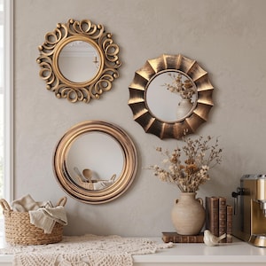 May include: Three circular wall mirrors with gold-toned frames. One mirror features an ornate scrollwork border, another has a sunburst-style pleated edge, and the third has a smooth, multi-layered concentric ring frame design.