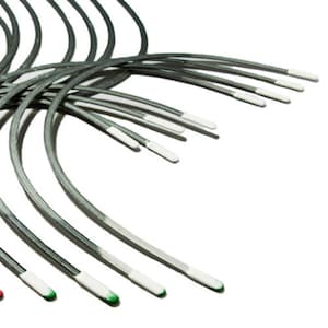 May include: A set of 12 silver-colored metal rods with white, green, and red colored tips. The rods are bent into a curved shape.