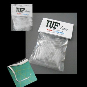 May include: A clear plastic bag filled with white shoelaces. The bag has a label that reads "TUF Laces Made in America Gulf Breeze Products - Sunny, Florida".