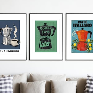 May include: Three framed art prints with coffee-themed illustrations. One print features a silver espresso maker, a cup of coffee, and the word "BUONGIORNO". Another shows a coffee pot silhouette with the text "Coffee First worries later". The third print displays an orange coffee maker with the words "CAFFÈ ITALIANO".