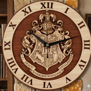 May include: A round wooden clock with a dark brown center and a light brown outer ring. The clock features Roman numerals and a detailed crest with the text "Draco Dormiens Nunquam Titillandus". The clock hands are black.