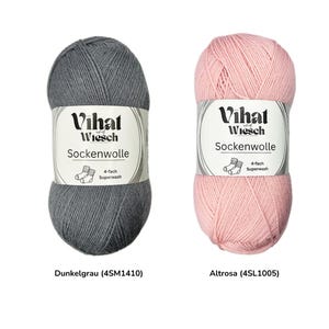 May include: Two skeins of Vihat Wiesch Sockenwolle yarn. One is dark gray, labeled "Dunkelgrau," and the other is light pink, labeled "Altrosa." Each skein has a white label with the brand name, yarn type, and "4-fach Superwash" text.
