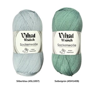 May include: Two skeins of Vihat Wiesch Sockenwolle yarn. One is a light blue color labeled "Silberblau", and the other is a sage green color labeled "Salbeigr&uuml;n". Each skein has a label with the brand name, yarn type, and "4-fach Superwash" text.