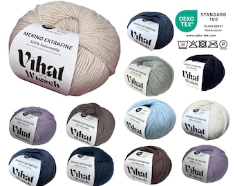 May include: A collection of merino wool yarn balls in various colors, including beige, blue, and gray. Each ball has a label with the text "MERINO EXTRAFINE" and the brand name "Vihat Wiesch". The image also includes an Oeko-Tex Standard 100 label.