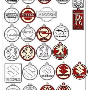 May include: A collection of car logo designs, including Mitsubishi, Nissan, Opel, Peugeot, Suzuki, Toyota, and Rolls Royce. The logos are in various styles, with red, white, and black color schemes. Each logo has a small hole at the top for hanging.