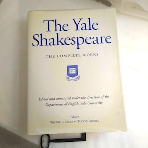May include: A hardcover book titled "The Yale Shakespeare: The Complete Works." The cover is off-white with blue text and a Yale University emblem. The book is edited and annotated by the Department of English, Yale University.