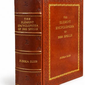 May include: A brown leather-bound hardcover book titled The Element Encyclopedia of 5000 Spells by Judika Illes. The cover and spine feature gold-colored embossed lettering and decorative border patterns with small etched symbols.