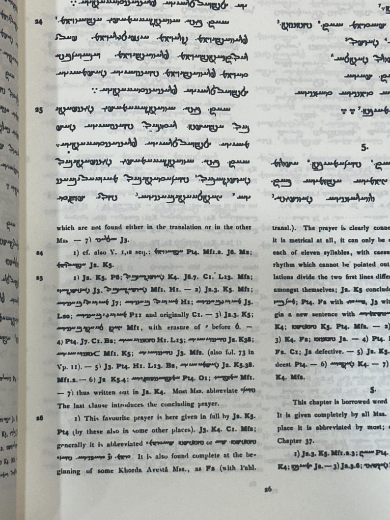 May include: Open book with text in an ancient script. The pages are yellowed, and the text is in black ink. The book is open to a page with multiple lines of text, with some numbers and abbreviations.