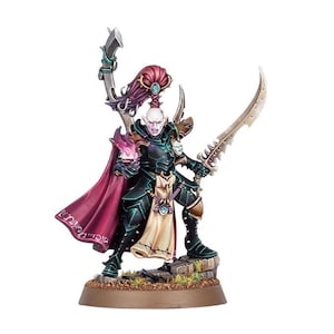 May include: A miniature fantasy figure of a warrior in black armor with green accents, holding a flaming purple orb and a curved sword. The figure has pale skin, a red cape, and is standing on a rocky base. A second curved blade is held in the other hand.