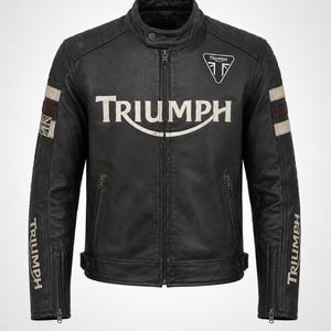 May include: A black leather motorcycle jacket featuring a central Triumph logo, a small Triumph emblem on the chest, and Triumph text on the sleeves. The sleeves include white and maroon stripes and a small Union Jack flag patch on the right arm.
