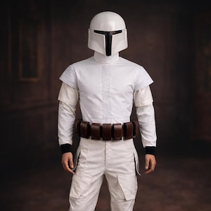May include: A white costume with a helmet, long-sleeved shirt, pants, and boots. The costume includes a brown belt with pouches. The helmet has a black visor. The outfit is reminiscent of a science fiction or fantasy character.