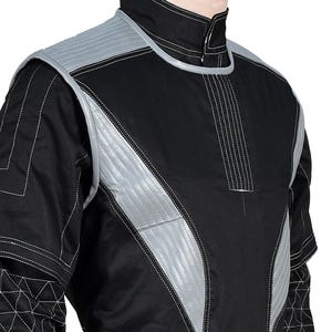 May include: Black jacket with silver accents and white stitching. The jacket features a high collar and quilted silver panels on the shoulders and chest. The design includes geometric patterns and a zipper closure at the neck.