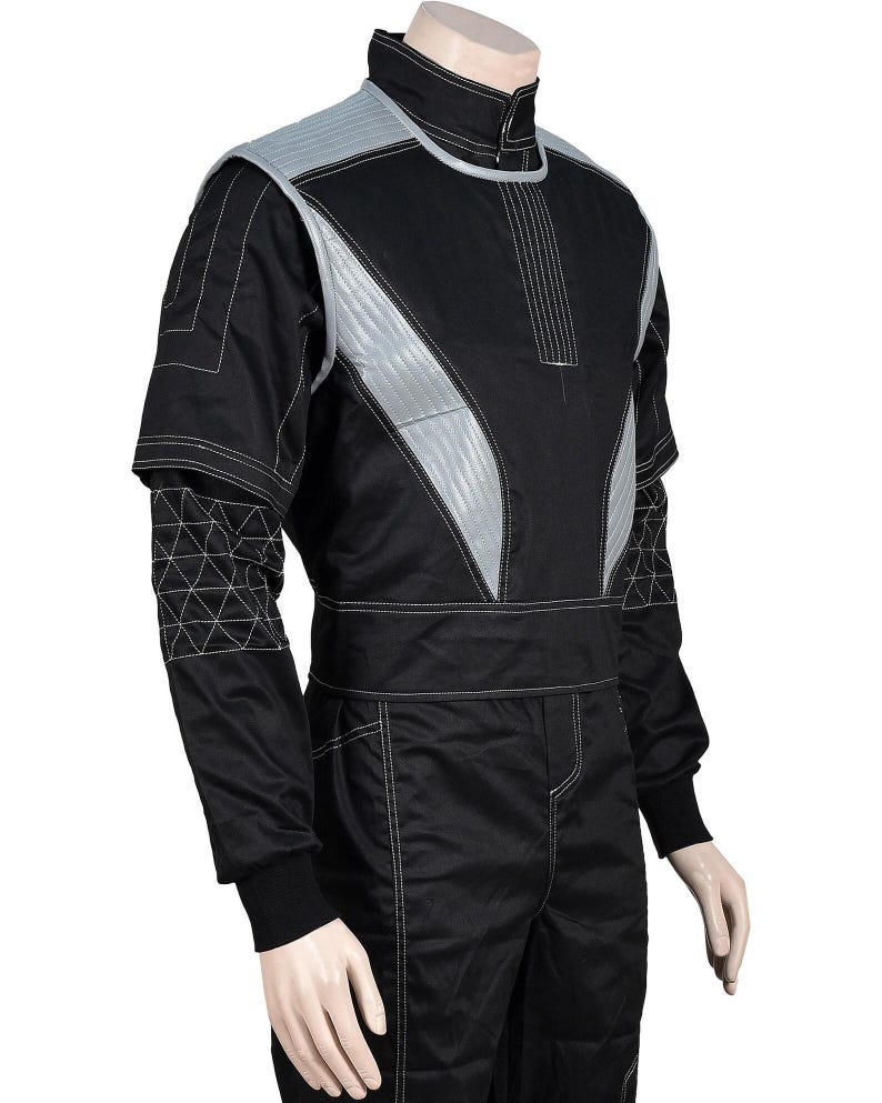 May include: Black racing suit with silver accents and white stitching. The suit features a high collar, quilted shoulder and chest panels, and geometric detailing on the sleeves. A black belt cinches the waist, and the suit appears to be made of a durable, possibly fire-resistant material.