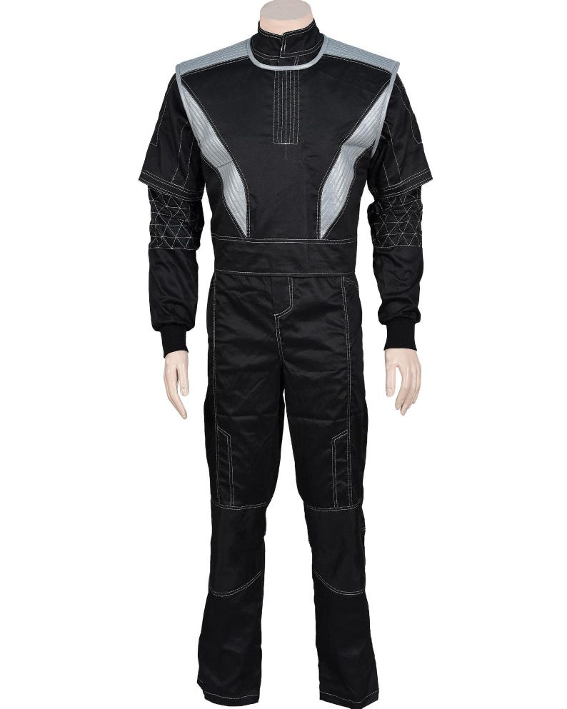 May include: Black racing suit with silver accents. The suit features a high collar, a front zipper, and white stitching details. The shoulders and upper chest have silver panels. The sleeves have a geometric design near the cuffs. The pants have reinforced knee panels.