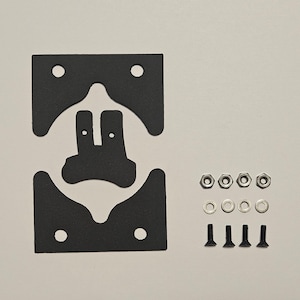 May include: A set of black gaskets with irregular shapes and holes, alongside nuts, washers, and screws. The components are arranged on a light surface, possibly for construction or repair.