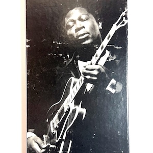 May include: A black and white album cover featuring B.B. King playing a guitar. The album title "B.B. King" is at the top, with "Chronicles 3 Classic Albums" below. The image is a portrait of the musician.