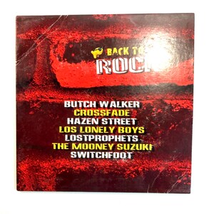May include: A square music CD case with a red and black distressed background. The text BACK TO ROCK appears at the top, followed by a list of artists including Butch Walker, Crossfade, Hazen Street, Los Lonely Boys, Lostprophets, The Mooney Suzuki, and Switchfoot.