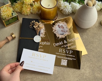 May include: Elegant wedding invitations with gold foil accents. The invitations feature the names "David & Sophia" and "Sophia" with the year "2024". An RSVP card is also included. The design is complemented by dried flowers and a wax seal.