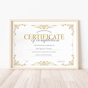 May include: A framed certificate with gold accents and text. The certificate reads "Certificate of Completion" and includes spaces for the company name, recipient name, course name, date, and trainer name.