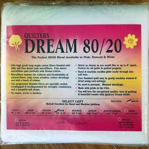 May include: Quilters Dream 80/20 batting is a blend of cotton and polyester fibers. It is available in pink, natural, and white. The batting is ideal for hand and machine quilting. The product is available in various sizes, including craft, crib, throw, twin, double, queen, super queen, and king.