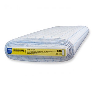 May include: A roll of white Tru-Grid tracing cloth with a blue grid pattern. The label reads "810 Tru-Grid" and "45 IN". The fabric is made of 85% polyester and 15% viscose. Ideal for crafts and home decor projects.
