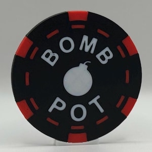May include: A black and red poker chip with the text "BOMB POT" in white. A white bomb graphic is in the center. The chip has a red outer ring with black accents.