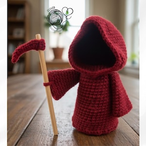 May include: A handmade, crocheted Grim Reaper figure in deep red, holding a wooden scythe. The figure has a hooded cloak and outstretched arms. The Clover Crochet Patterns logo is visible in the background.