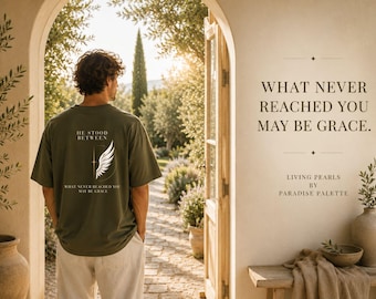 Puede incluir: Una camiseta verde oliva con un gráfico blanco de un ala y el texto HE STOOD BETWEEN WHAT NEVER REACHED YOU MAY BE GRACE. La camiseta se lleva con pantalones claros, y el texto WHAT NEVER REACHED YOU MAY BE GRACE. LIVING PEARLS BY PARADISE PALETTE aparece en la pared.