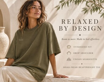 May include: An olive green oversized t-shirt with a drop shoulder and a small Paradise Palette logo on the chest. The text reads: RELAXED BY DESIGN, Room to move. Made to feel effortless. OVERSIZED FIT, DROP SHOULDER, UNISEX SILHOUETTE, SHAKA WEAR HEAVYWEIGHT TEE.