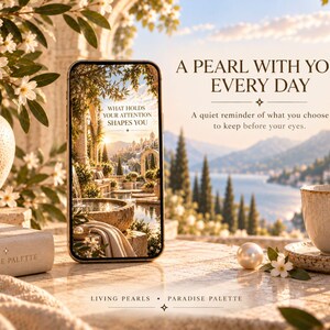 May include: A smartphone displaying a scenic garden image with the text WHAT HOLDS YOUR ATTENTION SHAPES YOU. Beside it sits a white ceramic cup, a single pearl, and a book labeled PARADISE PALETTE. Text reads A PEARL WITH YOU, EVERY DAY.