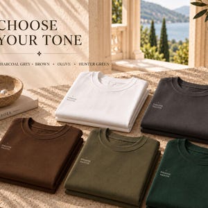 May include: Five folded crewneck sweatshirts in white, charcoal grey, brown, olive, and hunter green. Each shirt features the text "PARADISE PALETTE" printed on the chest. The text "CHOOSE YOUR TONE" and a list of the five available colors are visible.