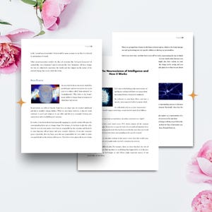 May include: A stack of open books with text and illustrations, titled "The Neuroscience of Intelligence and How it Works," is displayed on a white surface. Pink flowers are arranged around the books. The pages have text and images.