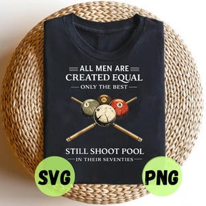 May include: Black t-shirt with the text "ALL MEN ARE CREATED EQUAL - ONLY THE BEST STILL SHOOT POOL IN THEIR SEVENTIES." The shirt features a graphic of pool balls and crossed pool cues. The shirt is on a woven surface.