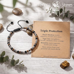 May include: A beaded bracelet featuring alternating black, brown, and metallic silver cylindrical beads on a black cord. The bracelet is displayed next to a tan card with the text Triple Protection, Black Obsidian, Tiger Eye, and Hematite.