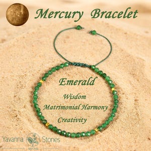 May include: Emerald bracelet with green beads and gold accents. The bracelet is on a sandy surface. Text on the image reads "Mercury Bracelet", "Emerald", "Wisdom", "Matrimonial Harmony", and "Creativity". The brand name "Yavanna Stones" is also visible.