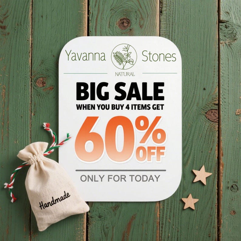 May include: A promotional image for Yavanna Stones featuring a white sign with "BIG SALE" text and a 60% off offer. A small beige bag with "Handmade" text and wooden stars are also present on a green wooden background.