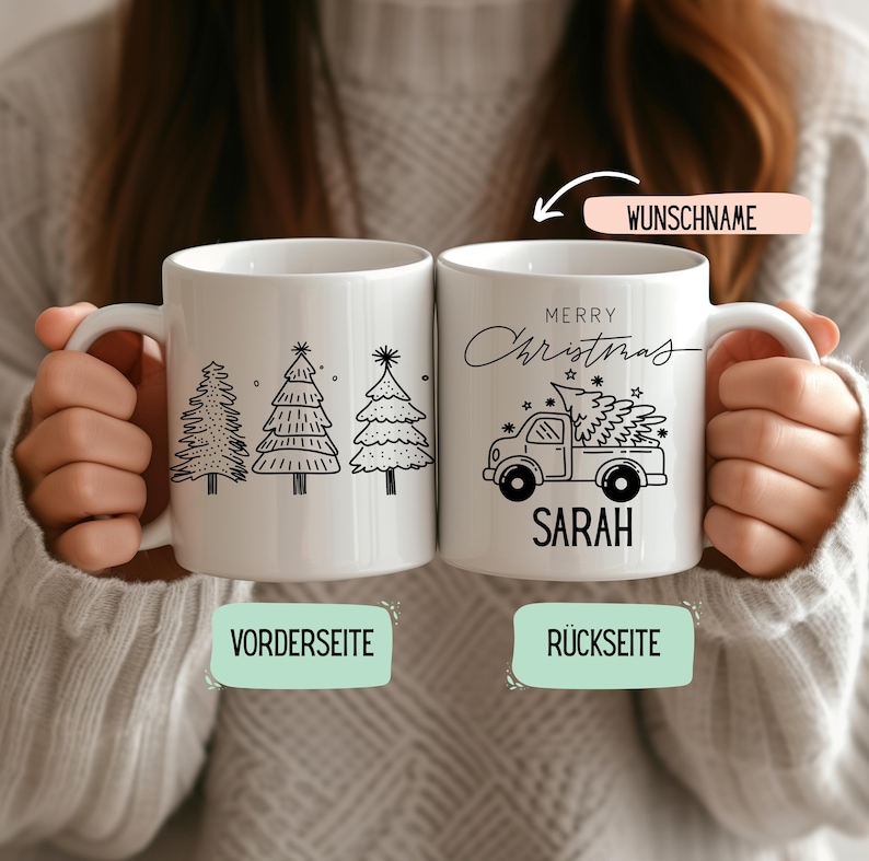May include: Two white ceramic mugs with black illustrations. One mug features three Christmas tree designs, and the other has a truck carrying a Christmas tree, with the text "MERRY Christmas" and the name "SARAH".