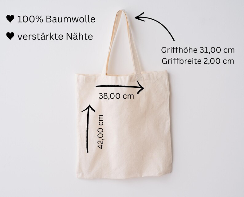 May include: A beige tote bag with cream-colored handles. The bag is 42 cm high and 38 cm wide. The handle height is 31 cm, and the handle width is 2 cm. The text on the bag says "100% Baumwolle" and "verst&auml;rkte N&auml;hte".