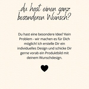 May include: A cream-coloured graphic with black handwritten text in German. The text reads "du hast einen ganz besonderen Wunsch?" and further text below. A black heart is at the bottom.