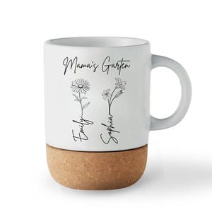 May include: White ceramic mug with a cork base. The mug features the text "Mama's Garten" and the names "Emily" and "Sophia" with floral illustrations. The handle is white.
