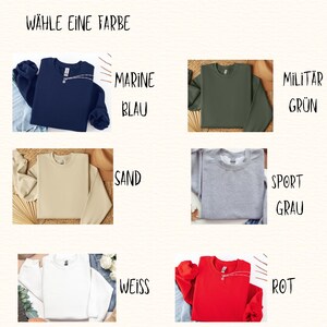 May include: A color chart featuring six crewneck sweatshirts with the text W&Auml;HLE EINE FARBE. The options are labeled MARINE BLAU, MILIT&Auml;R GR&Uuml;N, SAND, SPORT GRAU, WEISS, and ROT, displaying the sweatshirts in navy, olive green, beige, heather gray, white, and red.