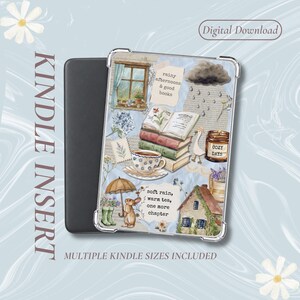 May include: A Kindle insert featuring a collage of watercolor illustrations including a window, a stack of books, a teacup, a candle labeled COZY DAYS, a rabbit, an umbrella, and a house. Text reads: rainy afternoons & good books and soft rain, warm tea, one more chapter.