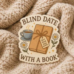 May include: A die-cut sticker featuring a brown wrapped book tied with string and a tag reading Your blind date awaits, a blue teacup on a saucer, and white daisies. The text BLIND DATE WITH A BOOK is printed in brown at the top and bottom.
