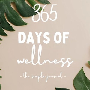 May include: A journal cover with the text "365 DAYS OF wellness - the simple journal" in white against a beige background. Green tropical leaves frame the text. The journal is designed for daily wellness practices.