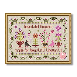 May include: Cross-stitch art with a gold frame. The design features the words "beautiful flowers make for beautiful thoughts" with floral and bird motifs in pink, purple, and green. The background is beige.