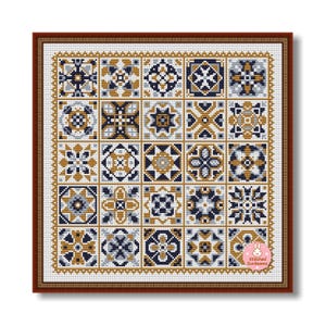 May include: A framed cross-stitch pattern featuring a grid of 25 geometric designs in shades of navy blue, gold, and gray. The designs are framed in a brown border. The lower right corner has a small logo with the text "Stitched Sunbeams".